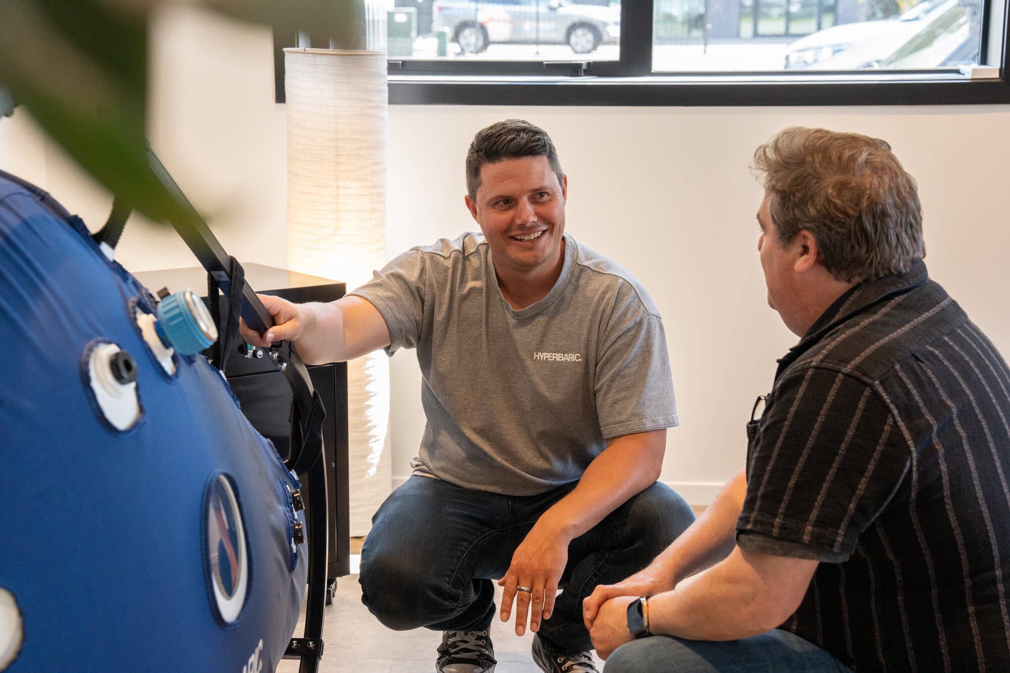 Callum demonstrating hyperbaric chamber features to a customer Callum demonstrating hyperbaric chamber features to a customer