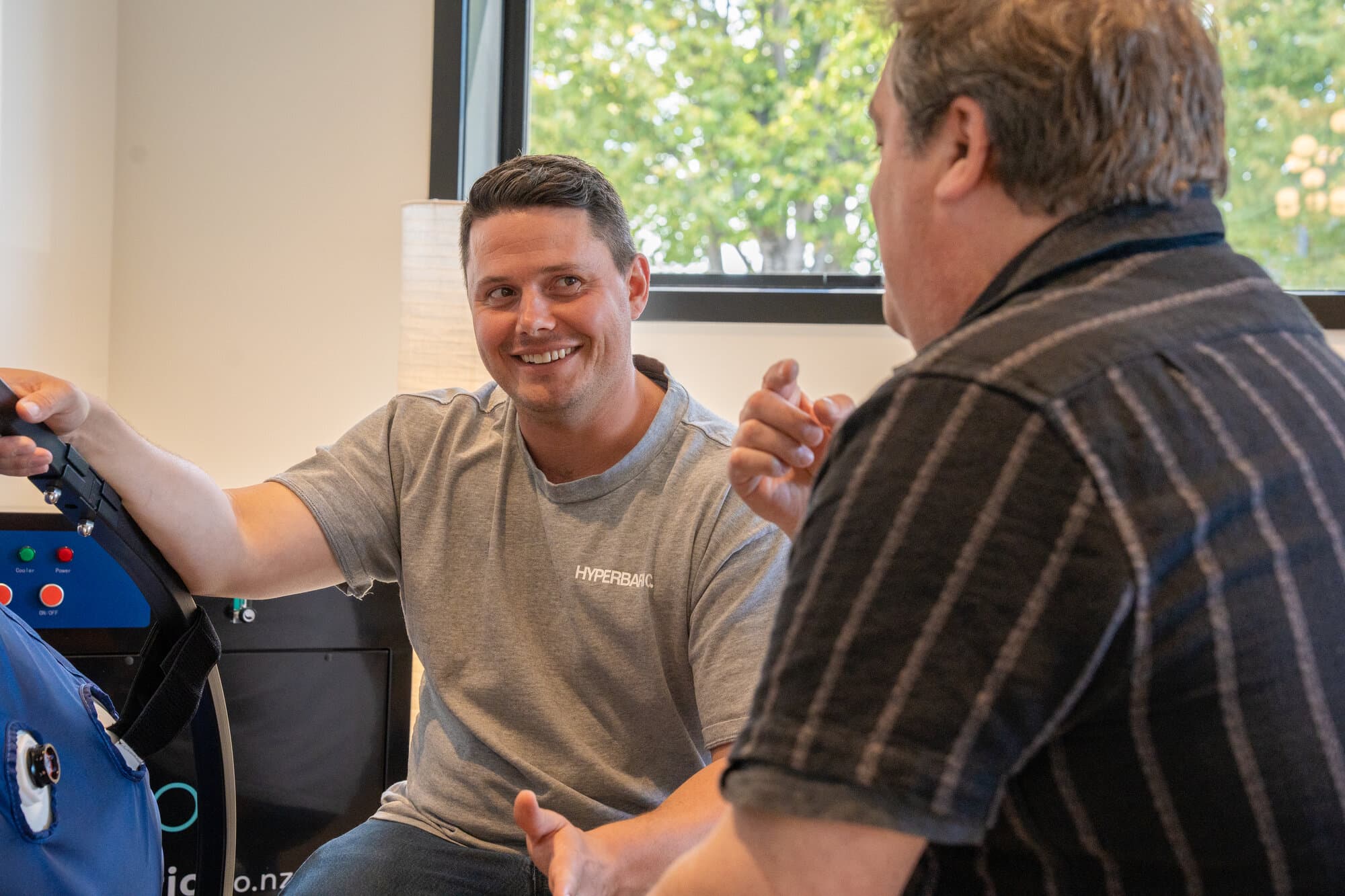 Callum smiling while explaining chamber features to a customer