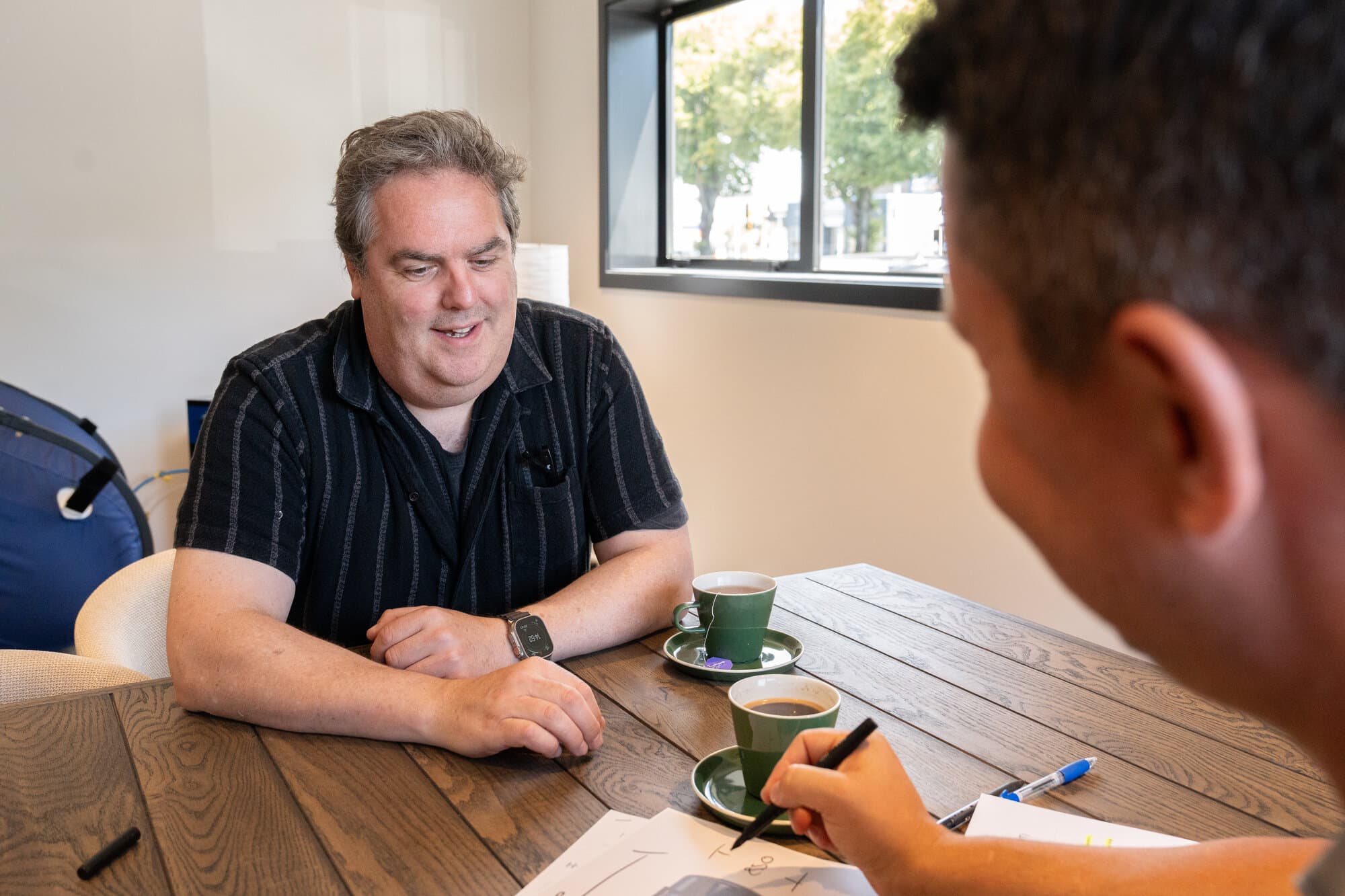 Callum having a consultation over coffee