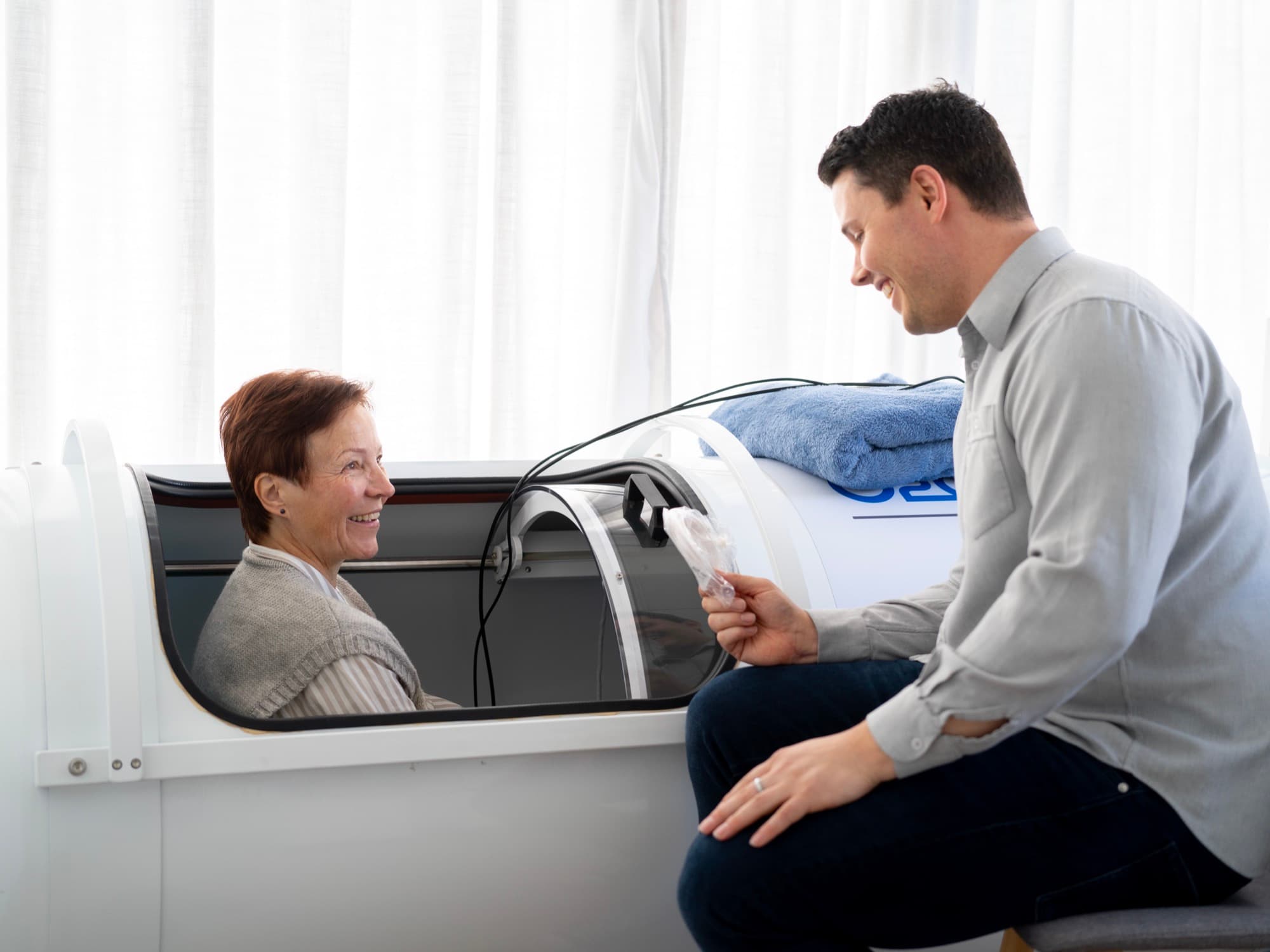 Customer in the hyperbaric chamber being guided through a session by Callum Customer in the hyperbaric chamber being guided through a session by Callum