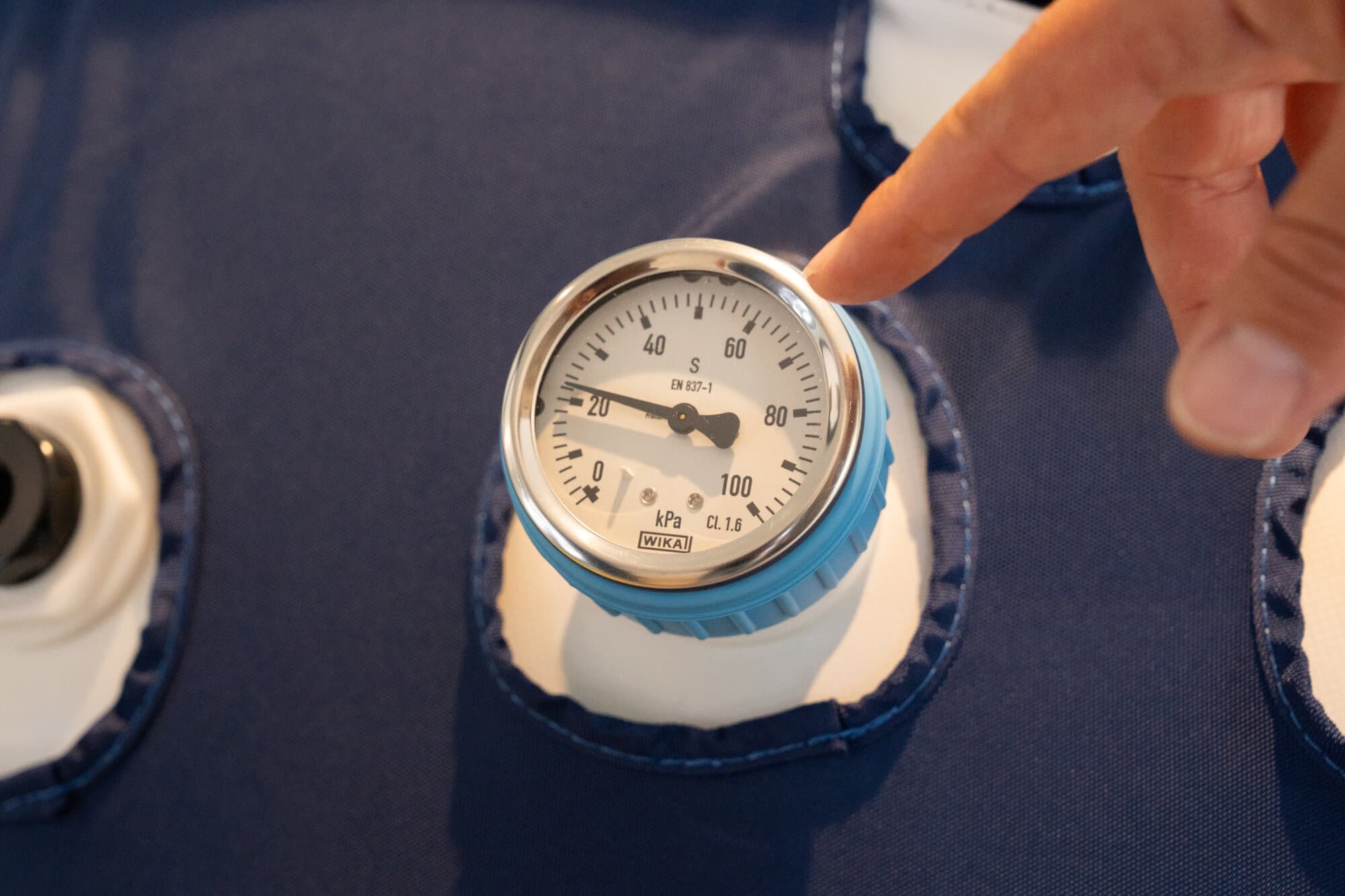 Close-up of a pressure gauge on a hyperbaric chamber showing atmospheric pressure readings