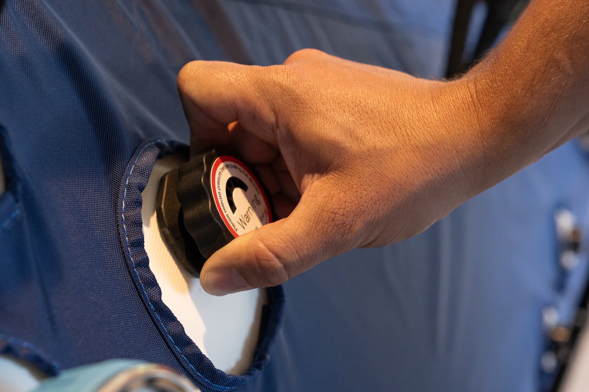 Hand demonstrating the pressure relief valve on the chamber